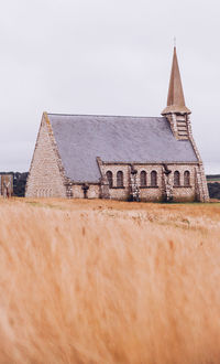 Old church on field against clear sky