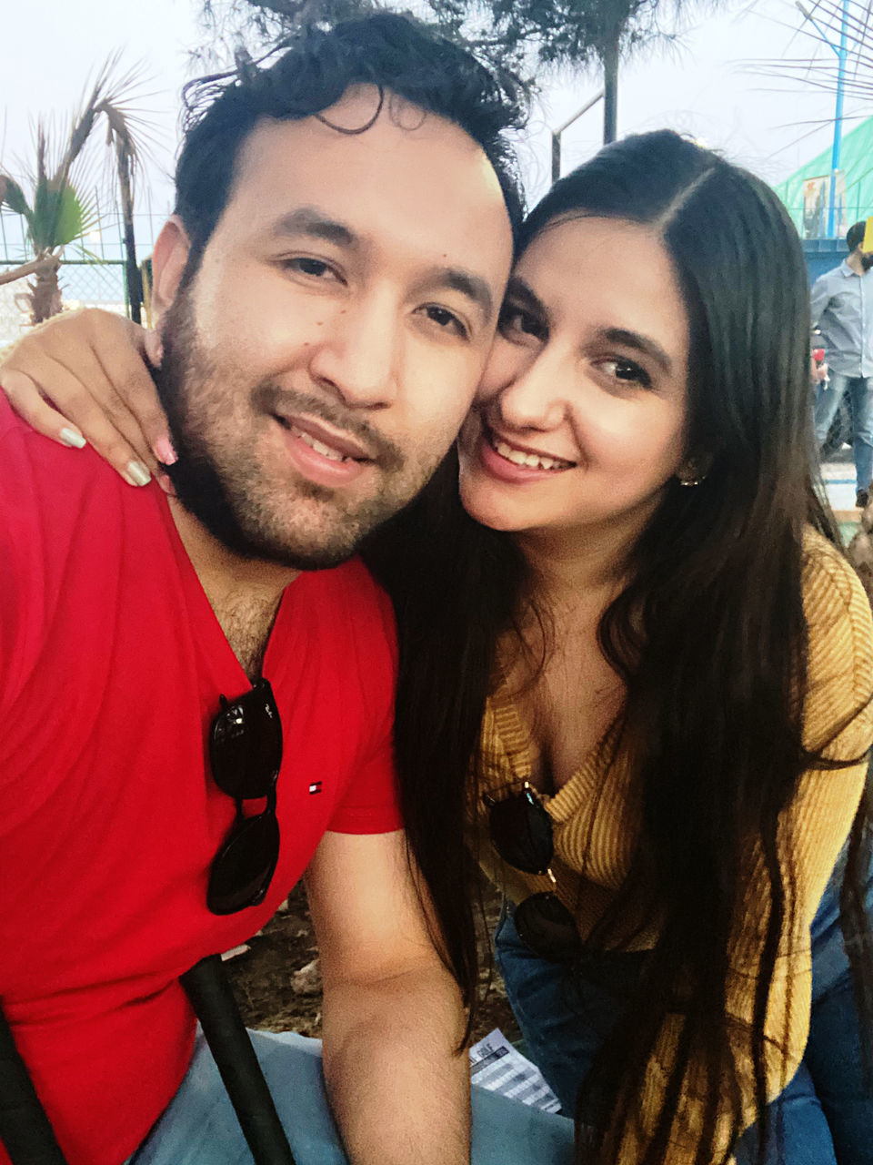 togetherness, adult, two people, young adult, emotion, portrait, smiling, happiness, love, positive emotion, women, men, bonding, looking at camera, lifestyles, person, casual clothing, leisure activity, affectionate, embracing, cheerful, romance, long hair, front view, friendship, beard, selfie, teenager, enjoyment, human face, headshot, facial hair, nature, photo shoot, clothing, wireless technology, camera, outdoors, fun, day, hairstyle, female, city, brown hair, tree