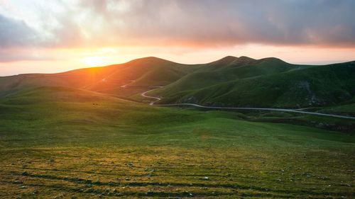 Scenic view of landscape against sky during sunset