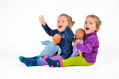 Happy friends playing against white background