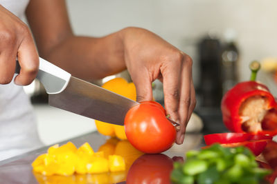 Midsection of man preparing fruits on table