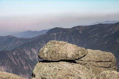 View of rocks on mountain against sky