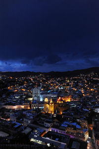 High angle view of illuminated buildings in city at night