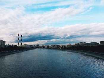 City by river against sky