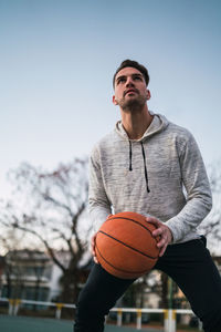 Young man playing with basketball