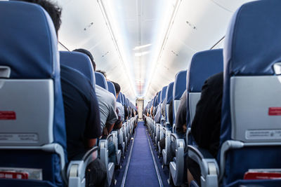 Rear view of people traveling in airplane