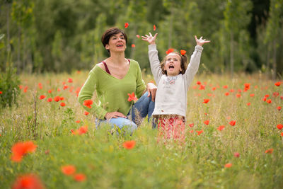 Mother and daughter playing in grassy field