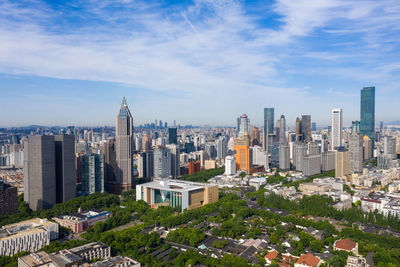 Aerial view of modern buildings in city against sky