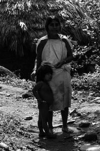 Full length of mother and daughter standing on land