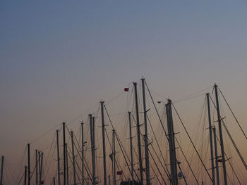 Low angle view of sailboats against clear sky during sunset