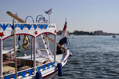 Decorated boat for excursions on nile river. there is an egyptian flag on bow of boat. luxor, egypt