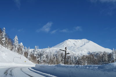 Snow covered mountain against blue sky