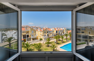 Buildings by swimming pool against sky