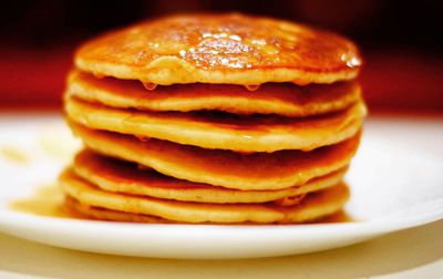 Close-up of stacked pancakes in plate on table