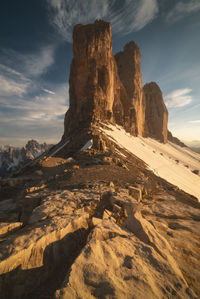 Rock formations on mountain against sky during sunset