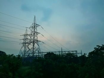 Low angle view of electricity pylon against sky