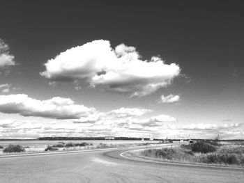 Road by landscape against sky