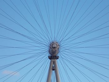 Low angle view of ferris wheel against blue sky