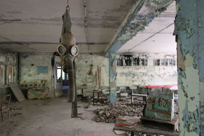 Gas mask hanging in abandoned building