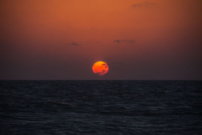 Scenic view of sea against romantic sky at sunset