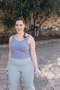 Portrait of smiling young woman standing outdoors