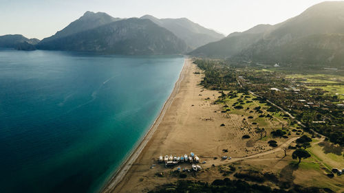 Scenic view of sea and mountains against sky