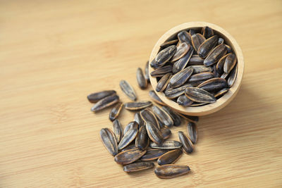 High angle view of roasted coffee beans on wooden table