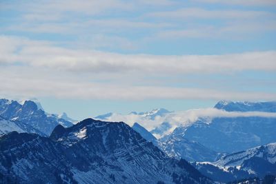 Scenic view of snow covered mountains against sky