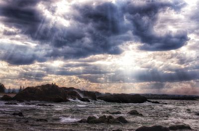 Scenic view of sea against cloudy sky