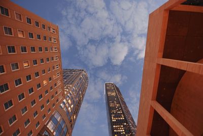 Low angle view of buildings against cloudy sky