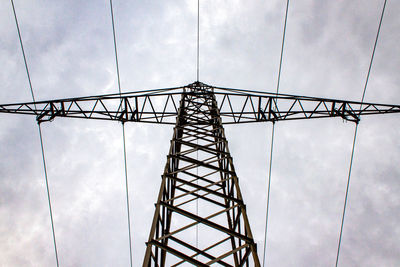 Low angle view of cranes against sky