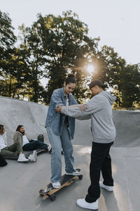 Teenage girl learning how to skate in skate park