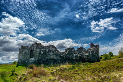 Old ruin building against cloudy sky