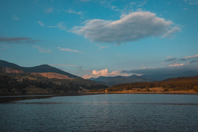 Scenic view of lake and mountains against sky