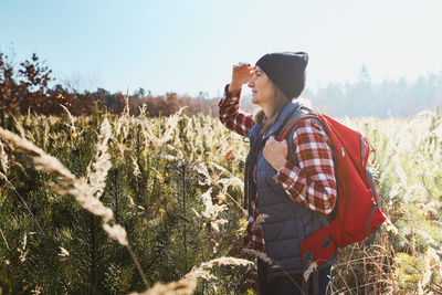 Young woman enjoying the view of mountains. woman with backpack hiking in mountains