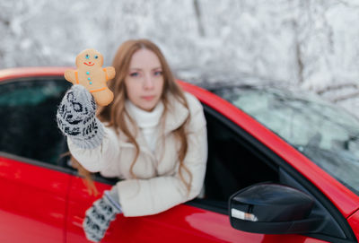 Portrait of young woman in car