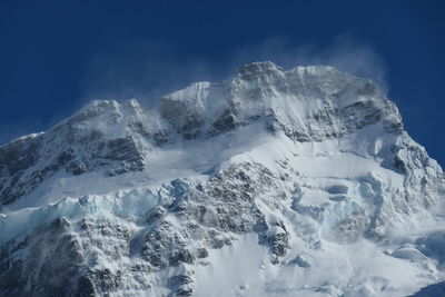 Wind blowing snow off the peak.