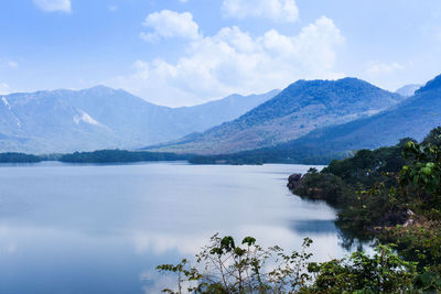 Scenic view of lake and mountains against sky