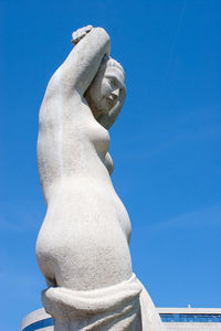 Low angle view of statue against blue sky