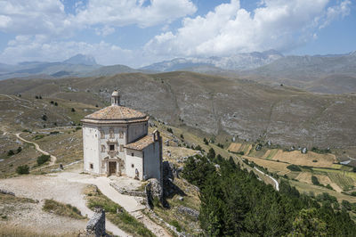 The church of santa maria della pietà in rocca calascio with the beautiful abruzzo mountains 