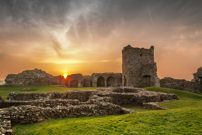 Old ruin building against cloudy sky during sunset
