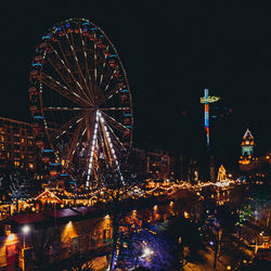 Illuminated ferris wheel at night