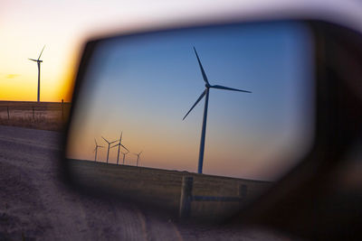 View of colorado wind farm from an automobile side mirror