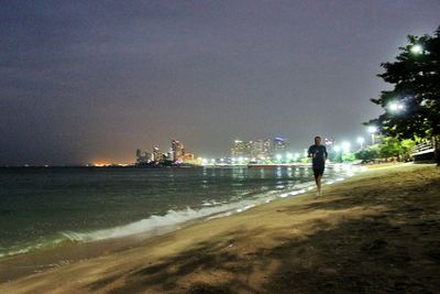 Woman walking in city at night