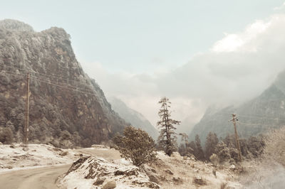 Scenic view of snow covered land against sky