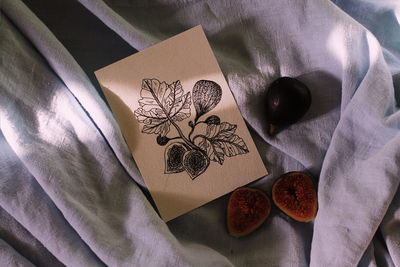 High angle view of paper and book on table