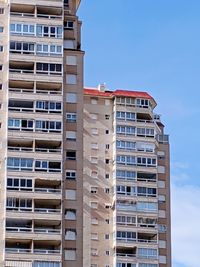 Low angle view of buildings against blue sky