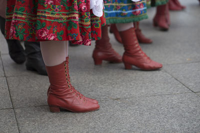 Low section of people traditional dancing on street in city