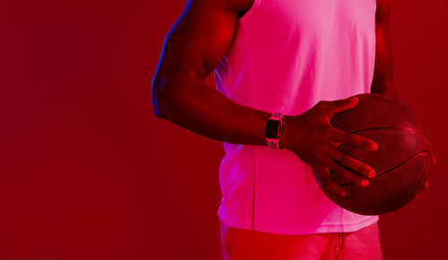 Midsection of man holding seashell