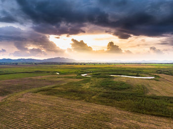 Scenic view of field against sky during sunset